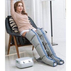 Siedząca osoba z mankietami na nogach oraz aparat